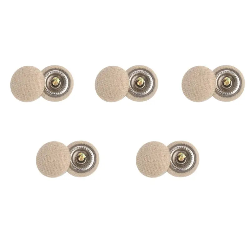 a set of four beige leather buttons with a gold button