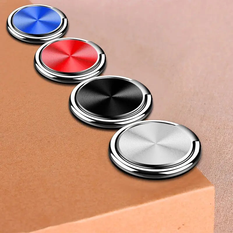 a set of three metal buttons on a brown surface