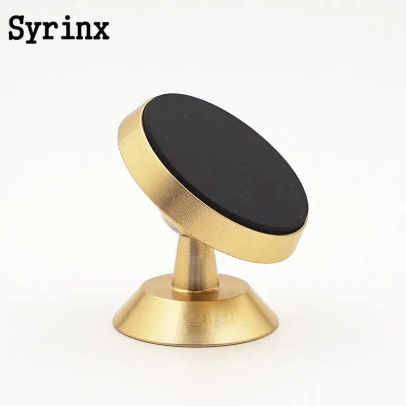 a gold metal knob with a black knob