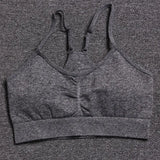 a close up of a gray sports bra top on a gray surface
