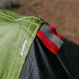 A close up of a green jacket with red and white stripes