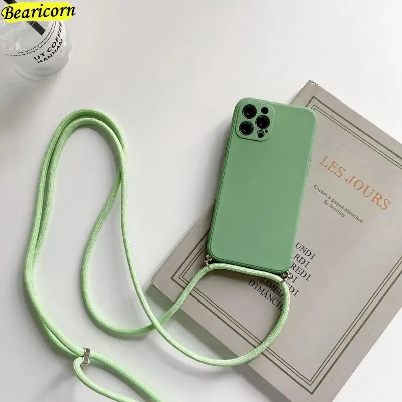there is a green phone case with a lanyard attached to it