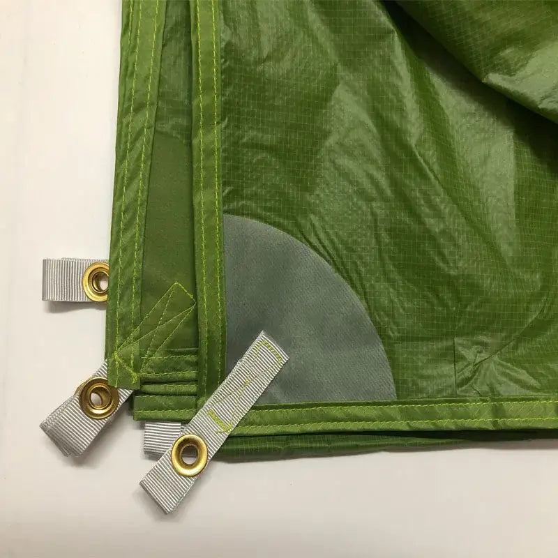 a close up of a green tarp with a zipper on it