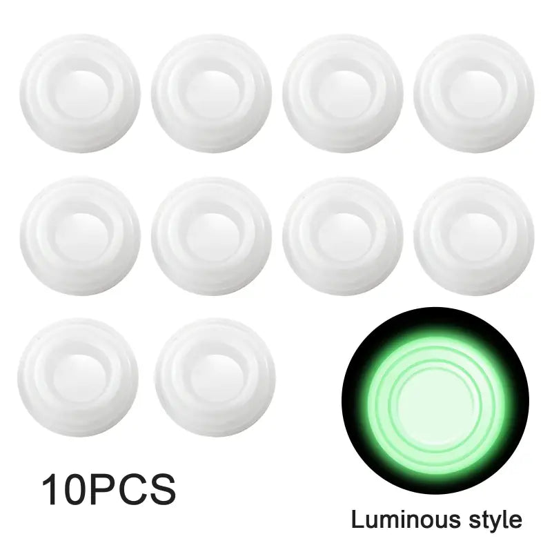 a close up of a green light in a white background