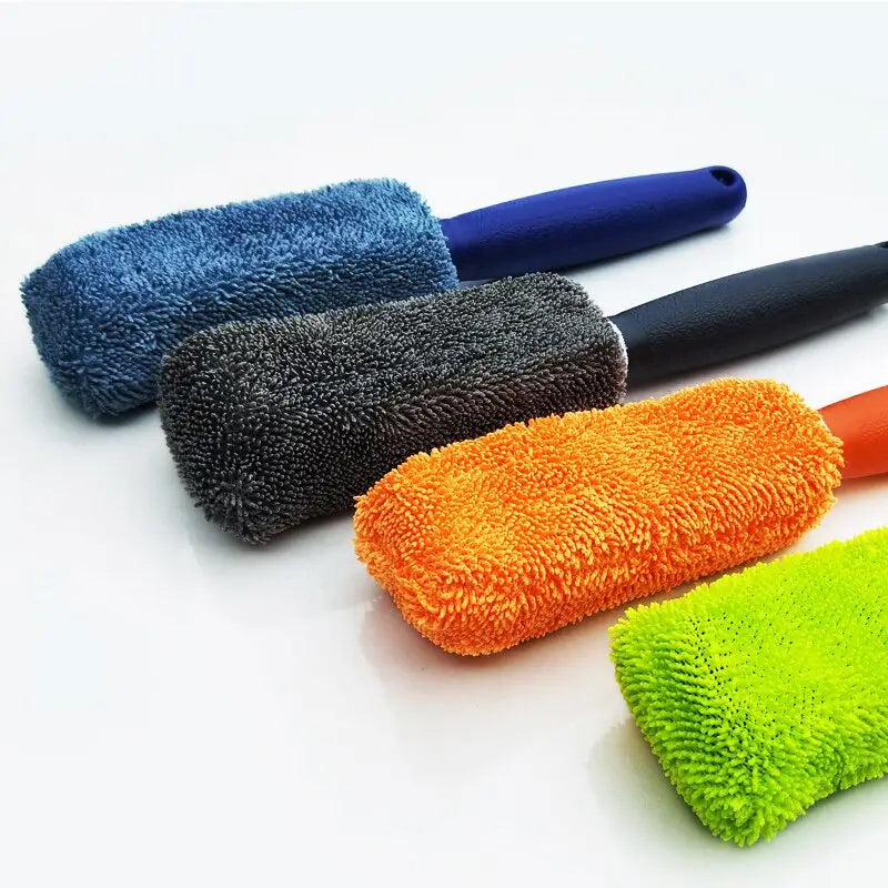 a close up of a group of different colored cleaning brushes
