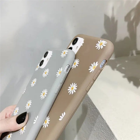 someone holding a phone with a daisy pattern on it