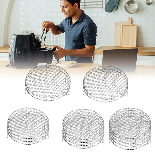 a close up of a man cooking in a kitchen with four baskets