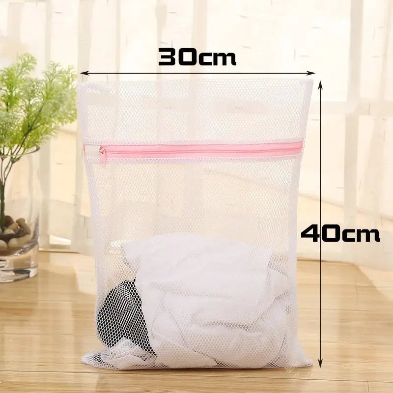 a white mesh bag with a pink zipper