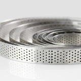 a close up of a metal bowl with a bunch of metal strainers