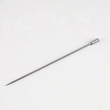 a close up of a metal needle on a white surface