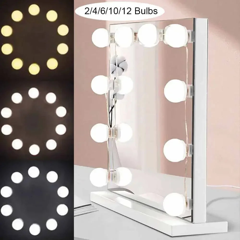 a close up of a mirror with lights on it and a mirror with a light on it