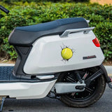 a close up of a motorcycle with a tennis ball on the back