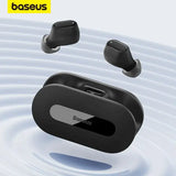 a close up of a pair of black earphones floating in water