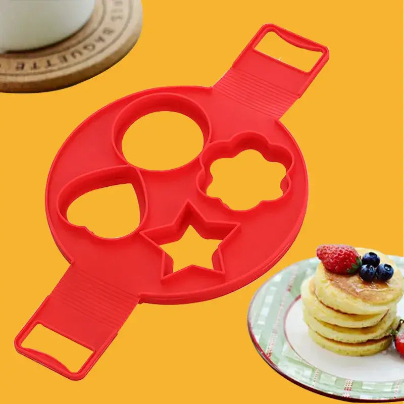 a close up of a pancake pan with pancakes and berries on a plate