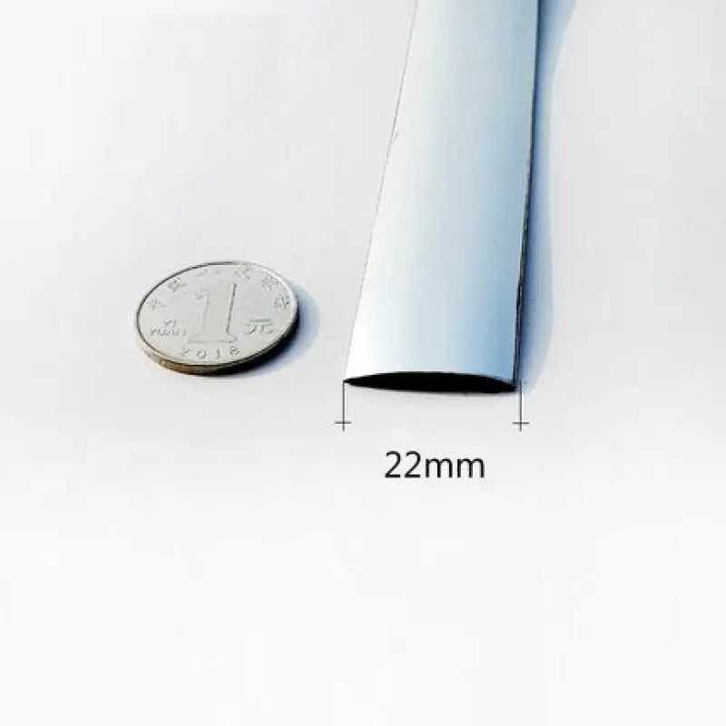 a close up of a quarter of a roll of white paper next to a coin