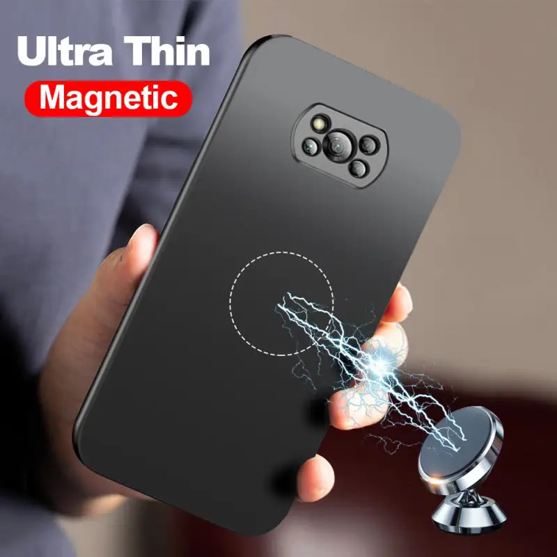 A close up of a person holding a cell phone with a magnet