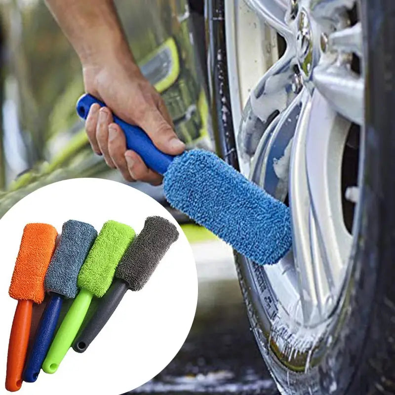 a close up of a person cleaning a car with a micro towel