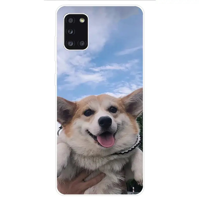 a close up of a person holding a dog on a cell phone