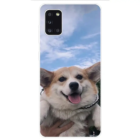 A close up of a person holding a dog on a cell phone