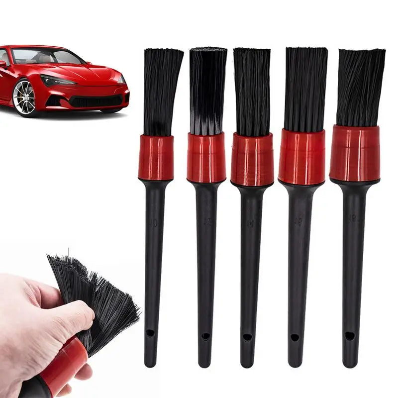 a close up of a person holding a brush near a red car