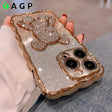 a woman holding a phone case with a gold glitter phone cover
