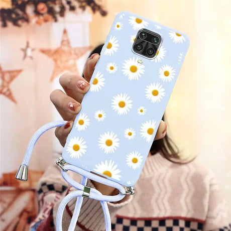 there is a woman holding a phone with a daisy pattern on it