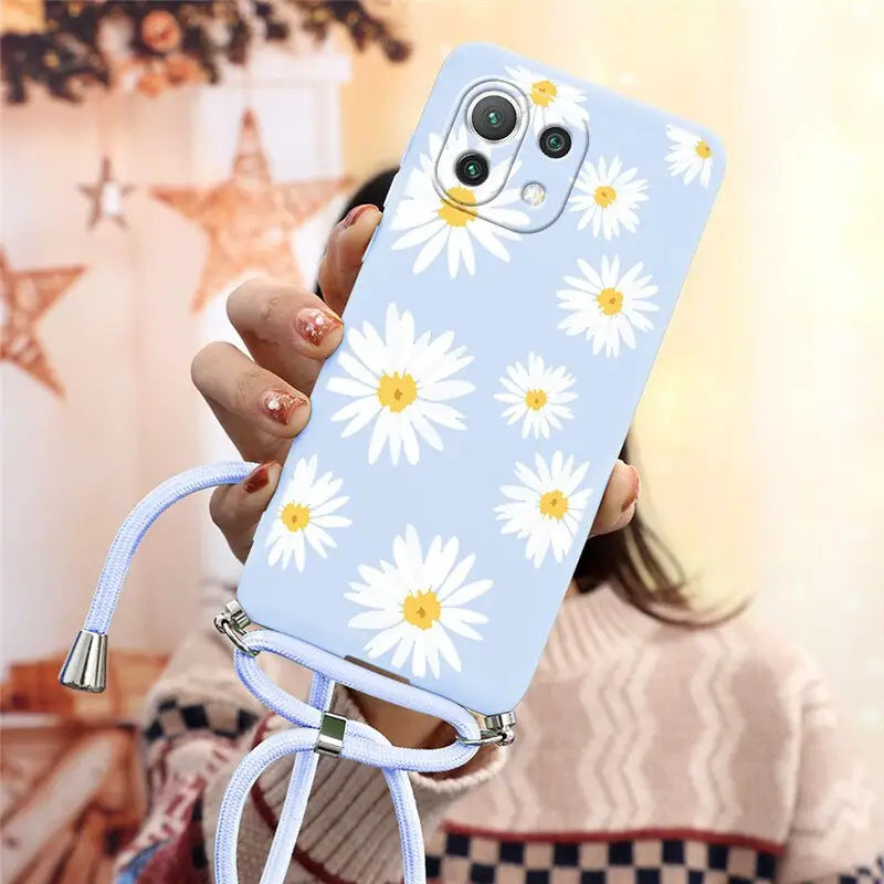 there is a woman holding a phone with a flower design on it