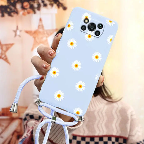 there is a woman holding a phone with a daisy pattern on it