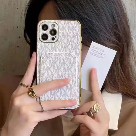 a woman holding a cell phone case