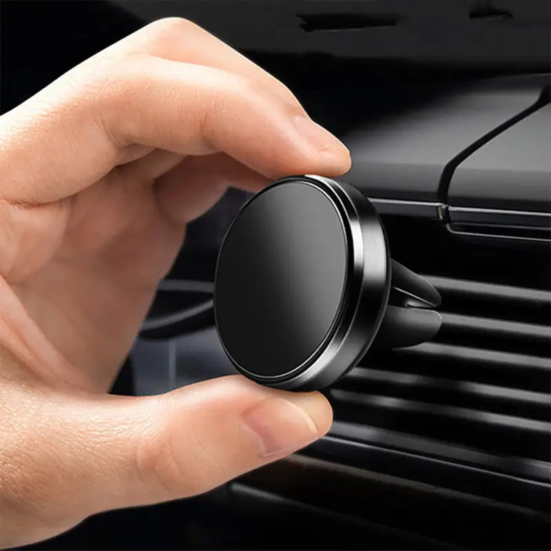 a close up of a person holding a car air vent