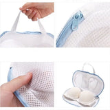 a hand holding a white mesh bag with two eggs inside