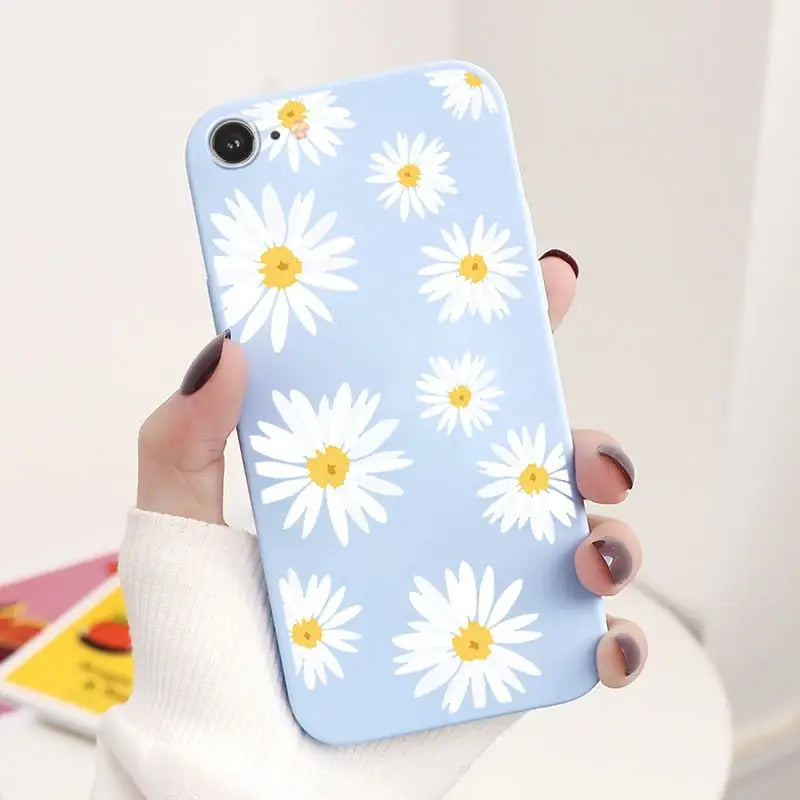 someone holding a phone with a flower pattern on it