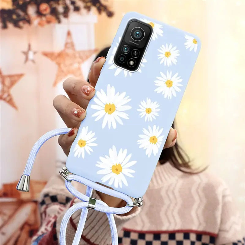 someone holding a phone with a flower design on it