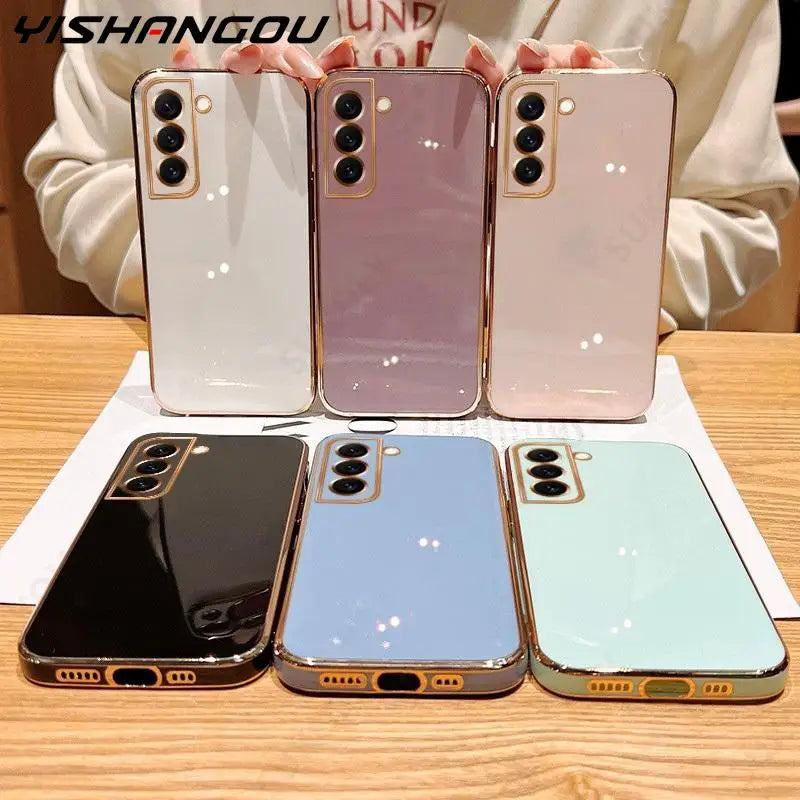 a woman holding a phone case in front of three different colors