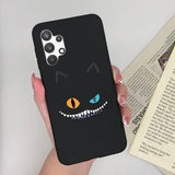 a person holding a phone case with a black cat face