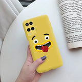 a person holding a yellow phone case with a cartoon face