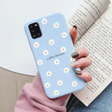 a close up of a person holding a phone case with daisies on it