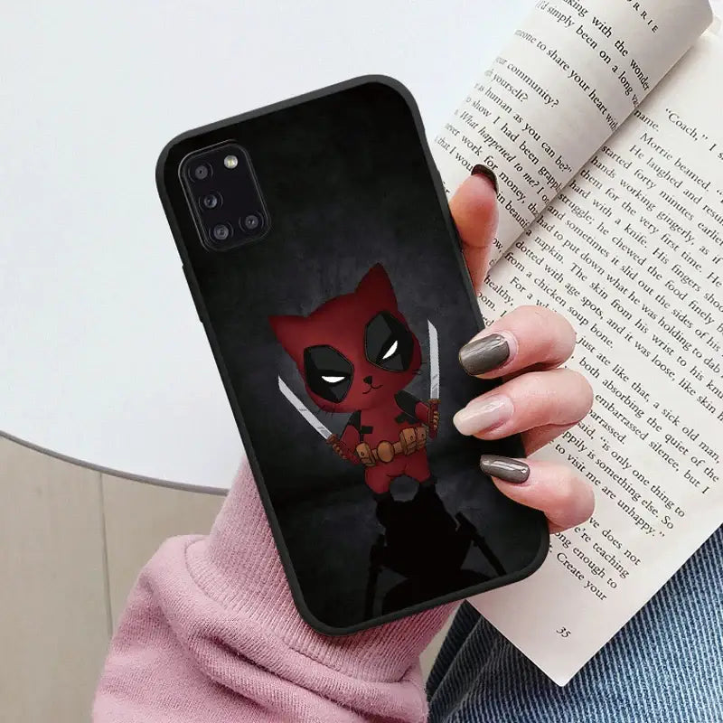 a close up of a person holding a phone case with a deadpool on it