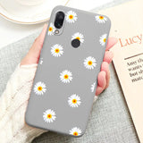 a close up of a person holding a phone with a flower pattern on it