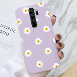 a close up of a person holding a purple phone case with daisies on it