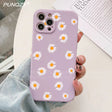 A close up of a person holding a purple phone case with daisies on it