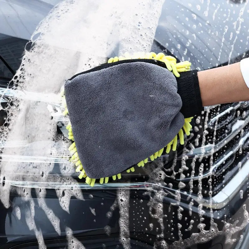 a person cleaning a car with a sponge