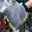 a close up of a person washing a car with a sponge