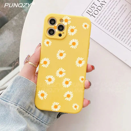 A close up of a person holding a yellow phone case