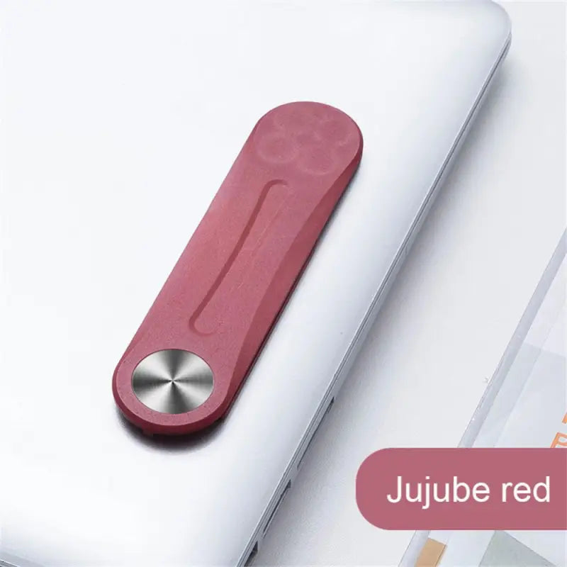 a red rubber rubber pad with a metal handle