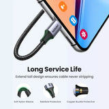 A close up of a phone with a charging cable attached to it