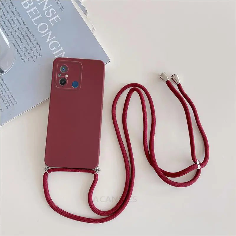 there is a red phone case with a red cord attached to it