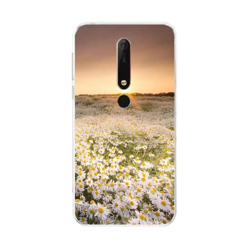 a white flower field with a sunset in the background