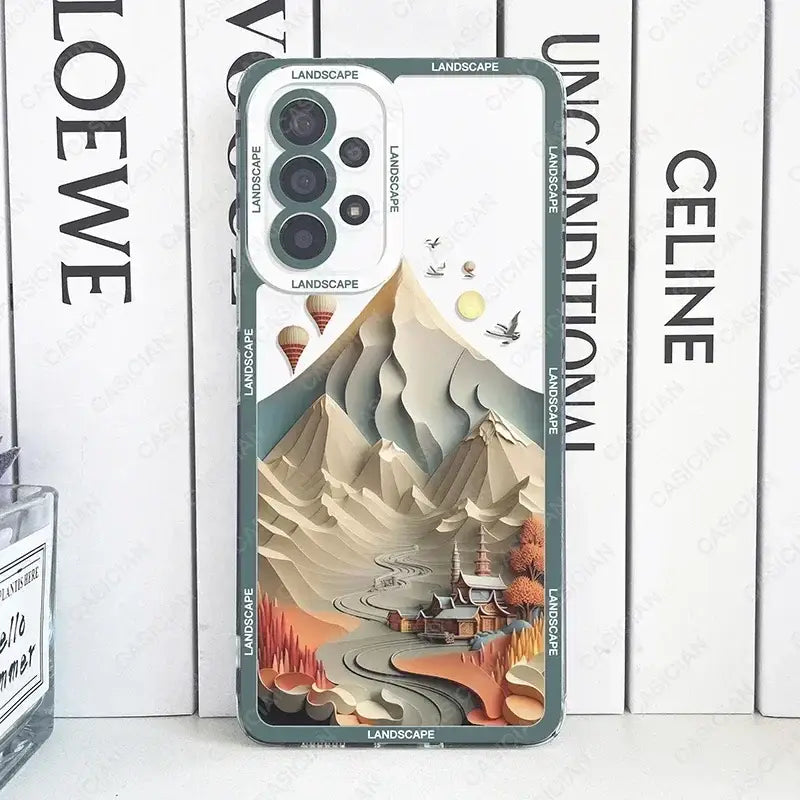 a close up of a phone case with a mountain scene