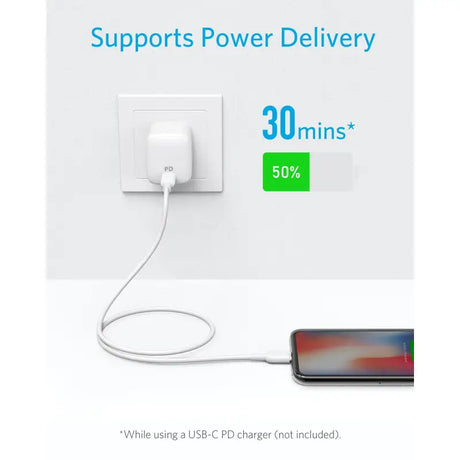 a white power outlet with a phone connected to it